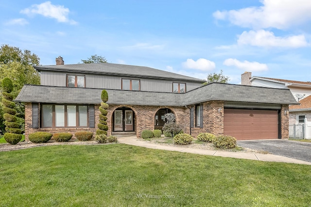 view of front of home featuring an attached garage, brick siding, driveway, a front lawn, and a chimney