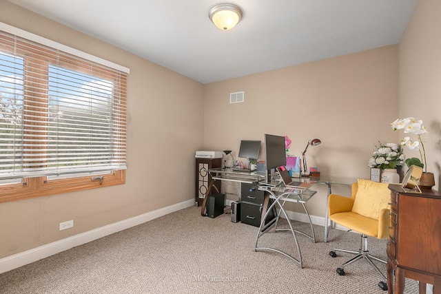 carpeted office featuring visible vents and baseboards