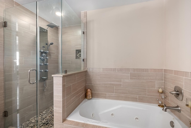 bathroom featuring a whirlpool tub and a stall shower