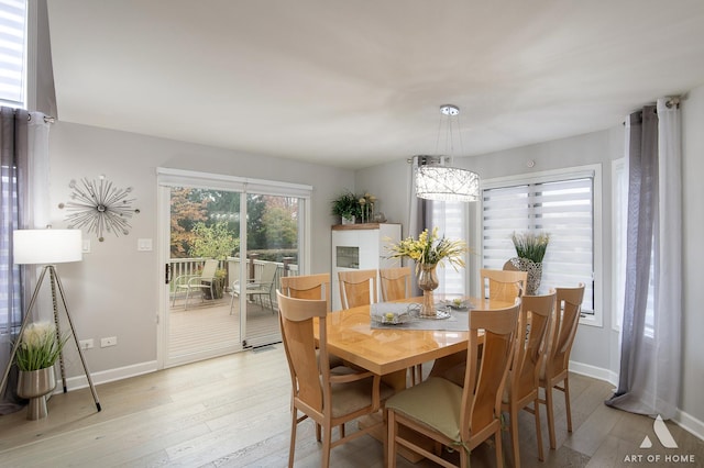 dining room with light wood-style flooring and baseboards