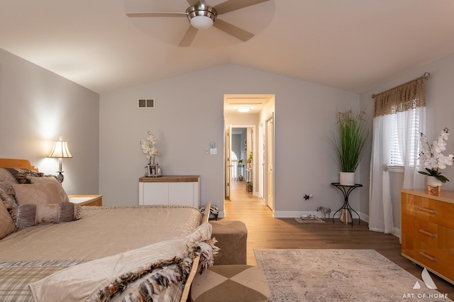 bedroom featuring visible vents, light wood-style flooring, vaulted ceiling, ceiling fan, and baseboards