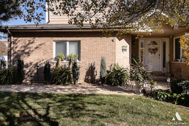 exterior space featuring a yard and brick siding