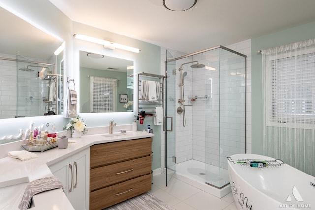 bathroom with a sink, double vanity, tile patterned flooring, and a shower stall