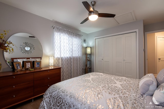 bedroom with a closet, attic access, and a ceiling fan