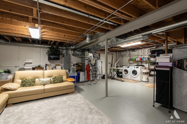 unfinished basement featuring water heater and independent washer and dryer