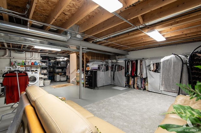 unfinished basement with washing machine and dryer and stairway