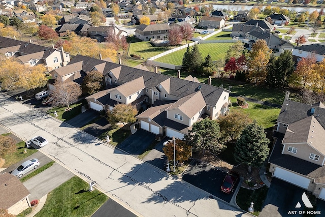 drone / aerial view featuring a water view and a residential view