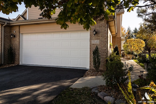 garage featuring aphalt driveway