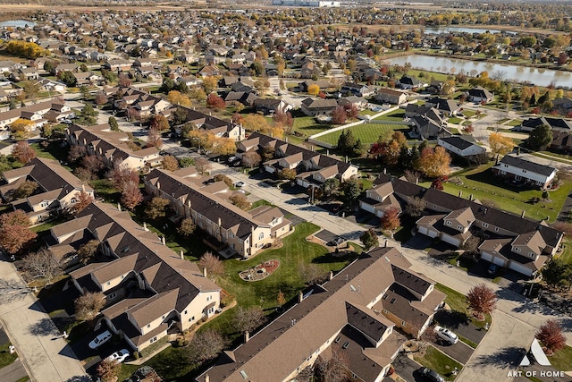 drone / aerial view featuring a water view and a residential view