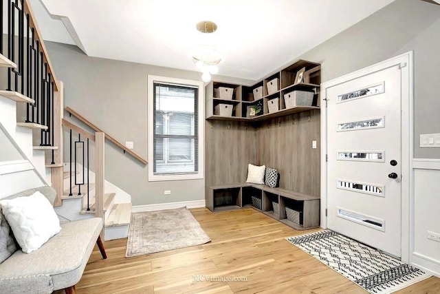 mudroom with wood finished floors and baseboards