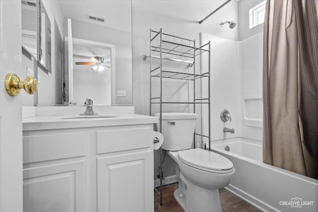 bathroom featuring vanity, wood finished floors, shower / bathtub combination with curtain, visible vents, and toilet