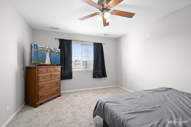 bedroom featuring baseboards, visible vents, and light carpet