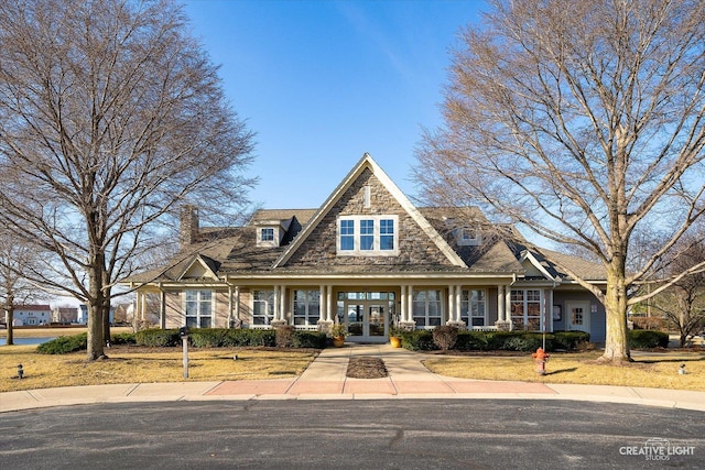 view of front of property with french doors and stone siding