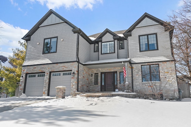 view of front of property featuring a garage, stone siding, and board and batten siding