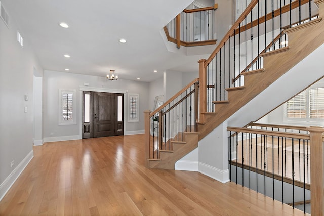 entryway featuring recessed lighting, visible vents, wood finished floors, a chandelier, and baseboards