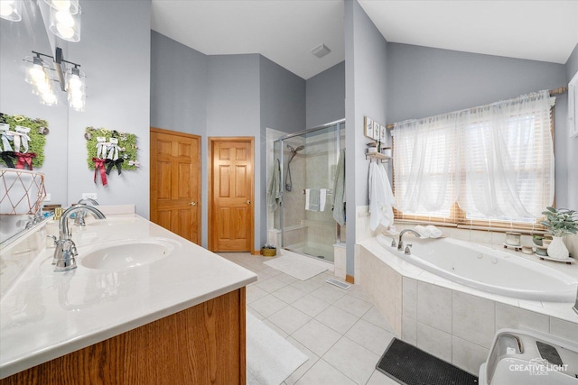 full bathroom with double vanity, lofted ceiling, a bath, tile patterned flooring, and a sink