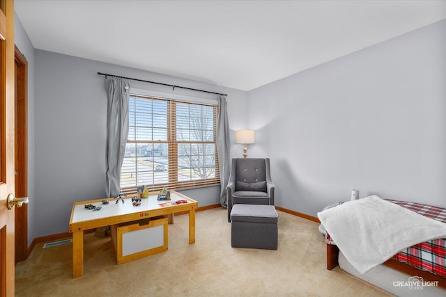 sitting room with carpet flooring, visible vents, and baseboards