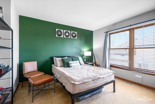 carpeted bedroom with visible vents, baseboards, and multiple windows