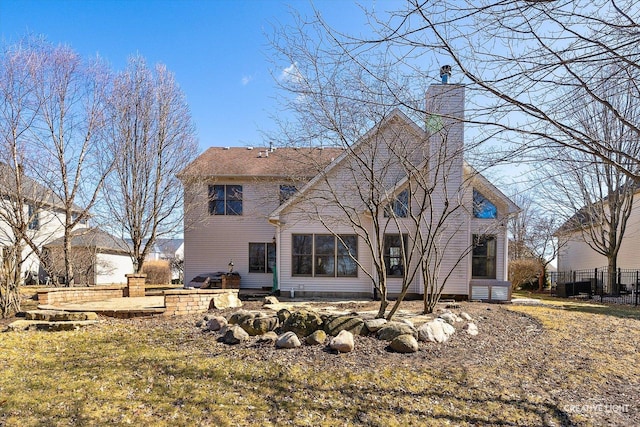 rear view of house featuring a chimney