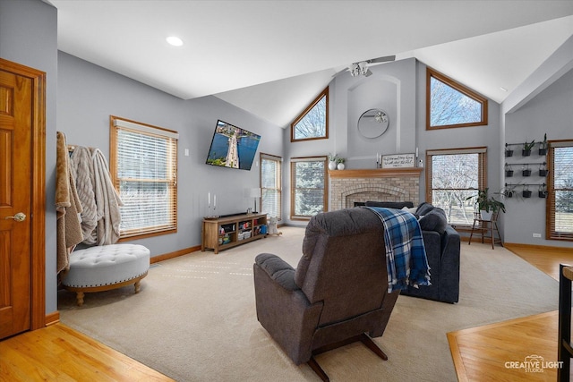 living area featuring carpet floors, a fireplace, wood finished floors, high vaulted ceiling, and baseboards