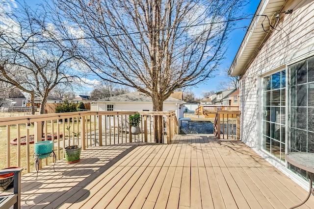 wooden terrace with a residential view and fence