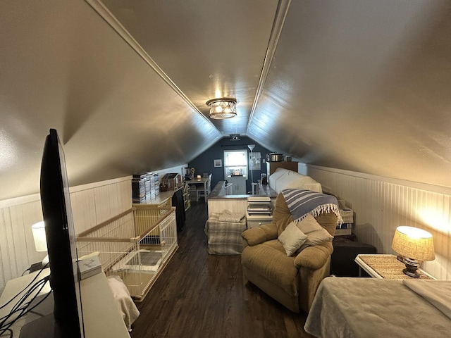 interior space with wainscoting, vaulted ceiling, and wood finished floors