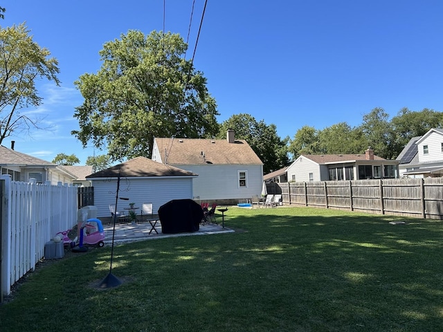 view of yard with a patio area and a fenced backyard