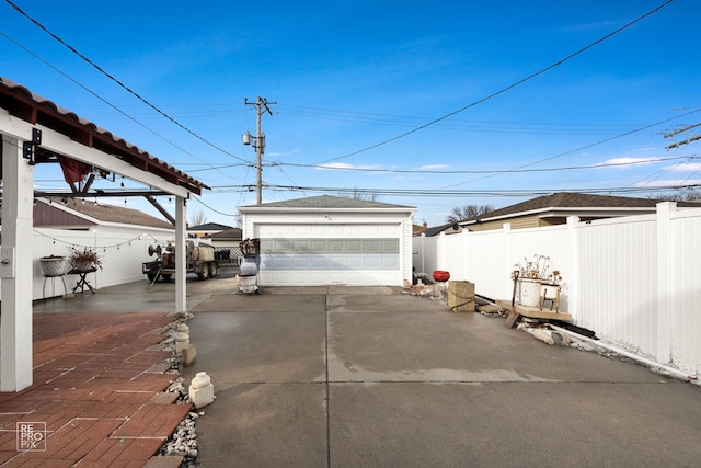 detached garage featuring fence