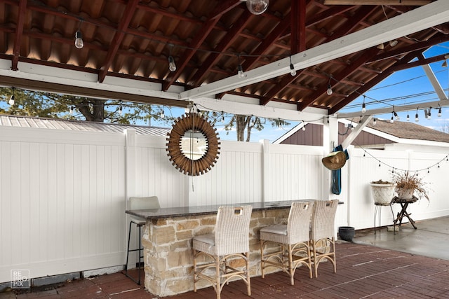 view of patio / terrace with outdoor dry bar, a gazebo, and fence