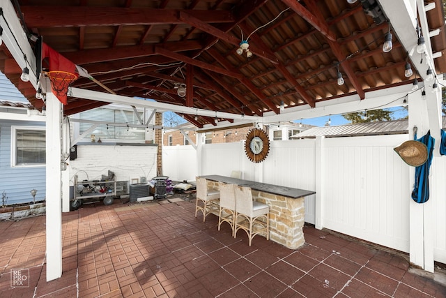 view of patio / terrace with outdoor dry bar, a gazebo, and fence