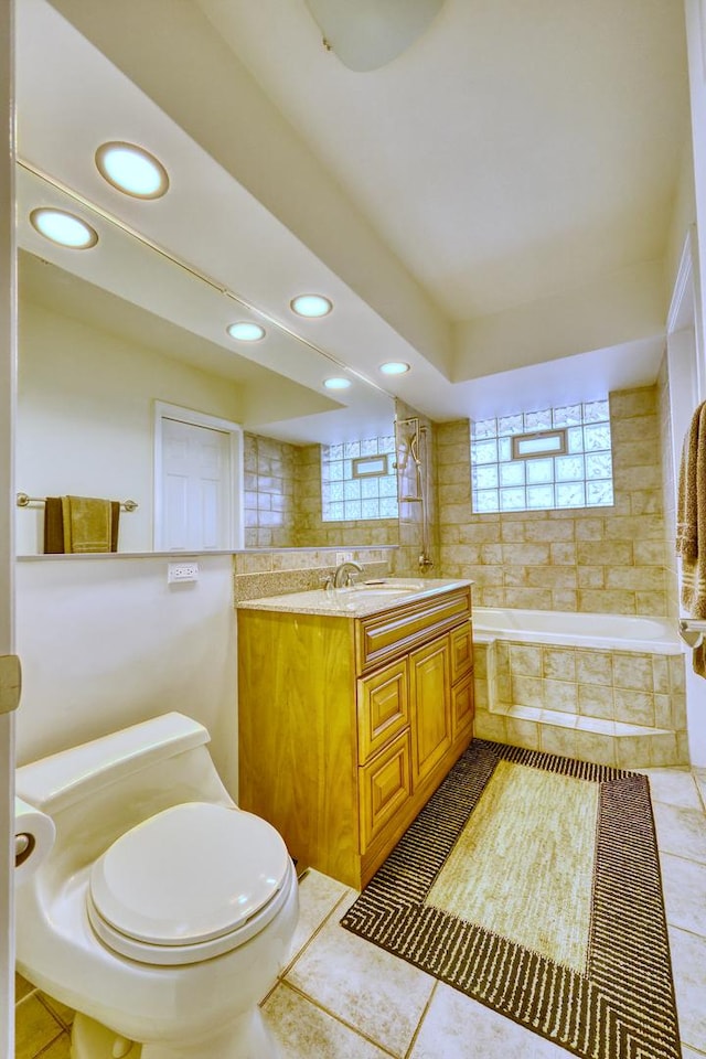 full bath featuring toilet, tile patterned flooring, vanity, tiled tub, and recessed lighting