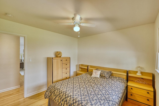 bedroom with light wood-style floors, baseboards, and a ceiling fan