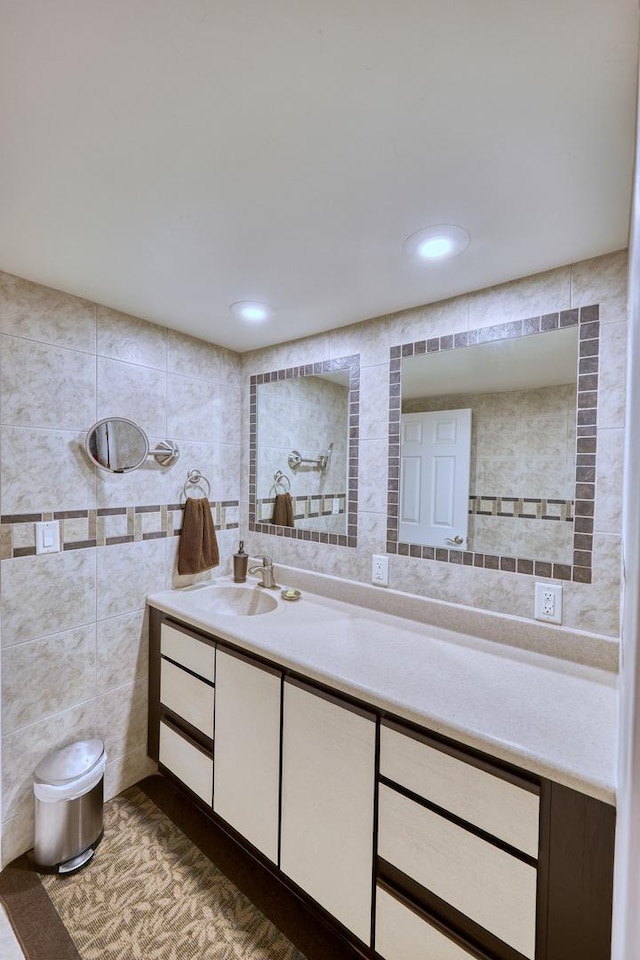 full bath featuring recessed lighting, tile walls, and vanity