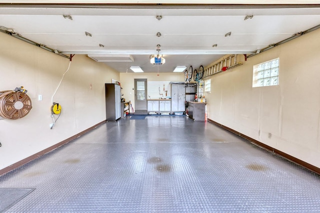 garage featuring a garage door opener and baseboards