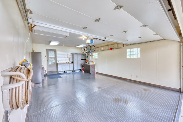 garage featuring a garage door opener and baseboards