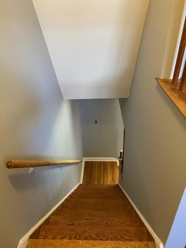 stairs with baseboards and wood finished floors