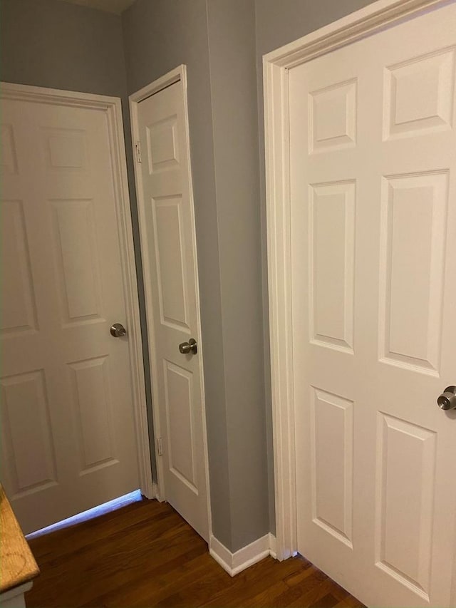 interior space featuring baseboards and wood finished floors