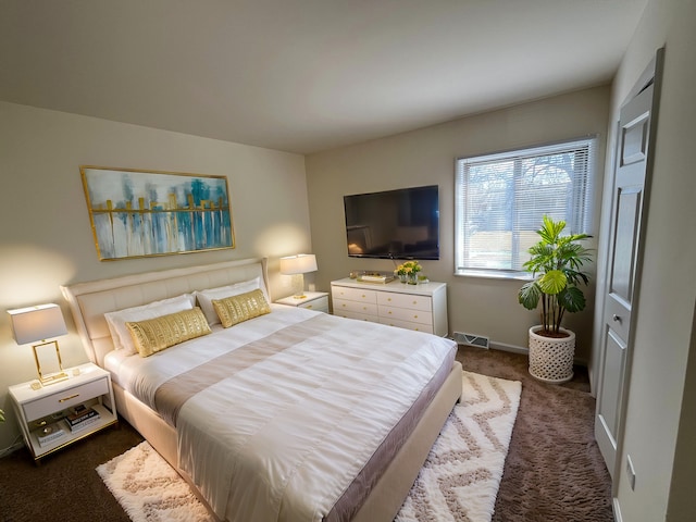 carpeted bedroom with visible vents and baseboards