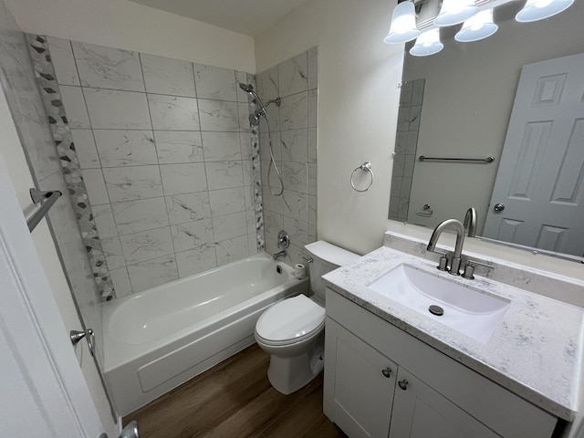 full bathroom featuring toilet, bathtub / shower combination, wood finished floors, and vanity