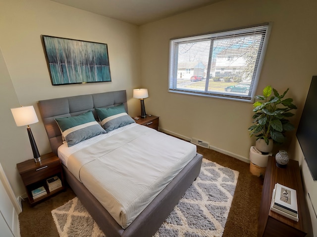 carpeted bedroom with visible vents and baseboards