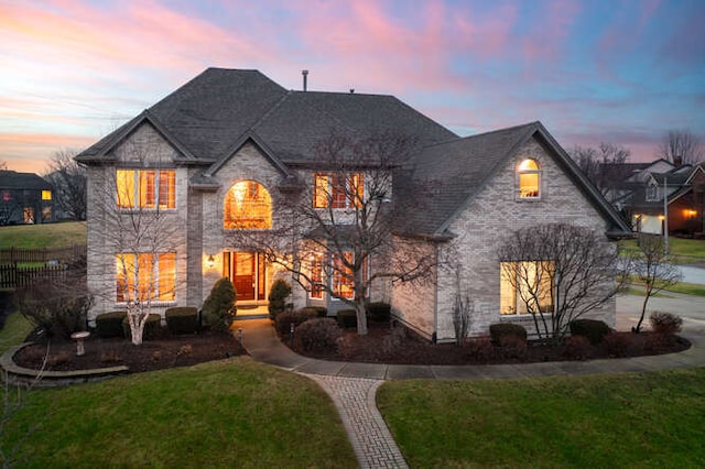 french provincial home featuring a lawn