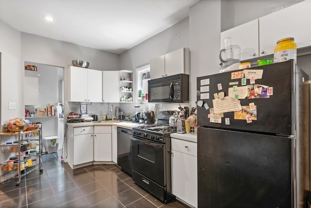 kitchen featuring tasteful backsplash, light countertops, black appliances, white cabinetry, and a sink