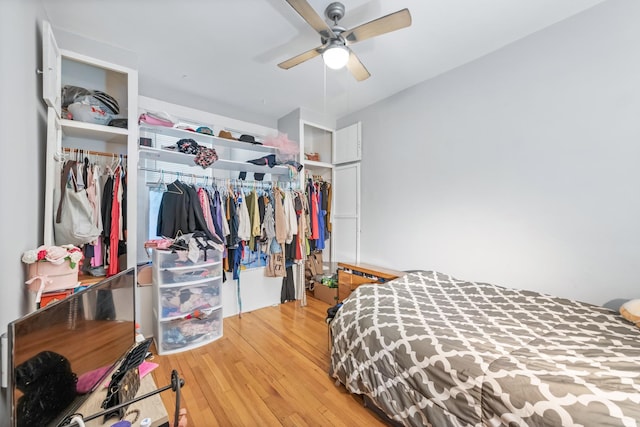 bedroom featuring ceiling fan, a closet, and wood finished floors