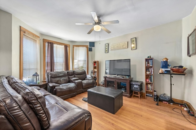 living room featuring light wood-style floors and a ceiling fan