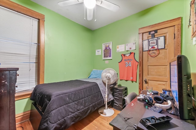 bedroom with a ceiling fan and wood finished floors