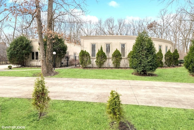 view of front of home with stucco siding and a front yard