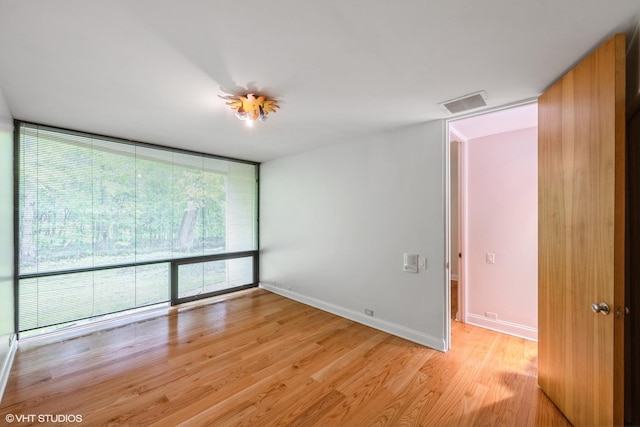 2000 Clendenin Ln, Riverwoods, IL 60015 - unfurnished room with floor to ceiling windows and light wood finished floors