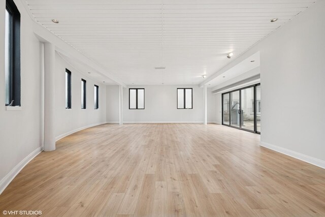 empty room with light wood finished floors and baseboards