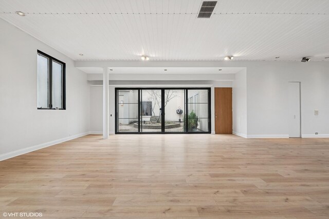 unfurnished room with light wood-style floors and baseboards
