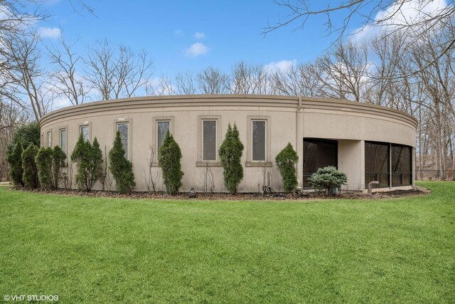 view of property exterior with a lawn and stucco siding